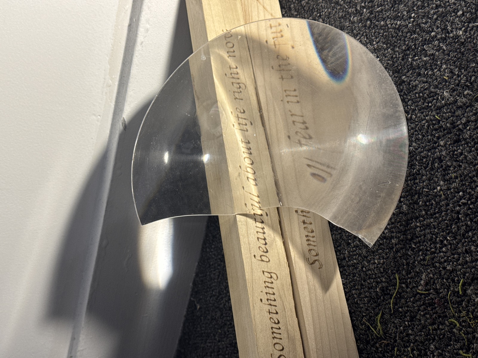 Bloom exhibition — clear acrylic disc with engraved text